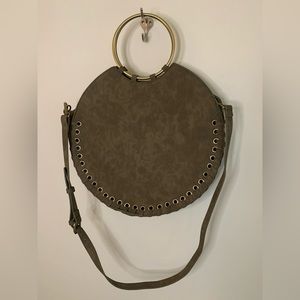 Round dark green Anthropologie purse with gold accents